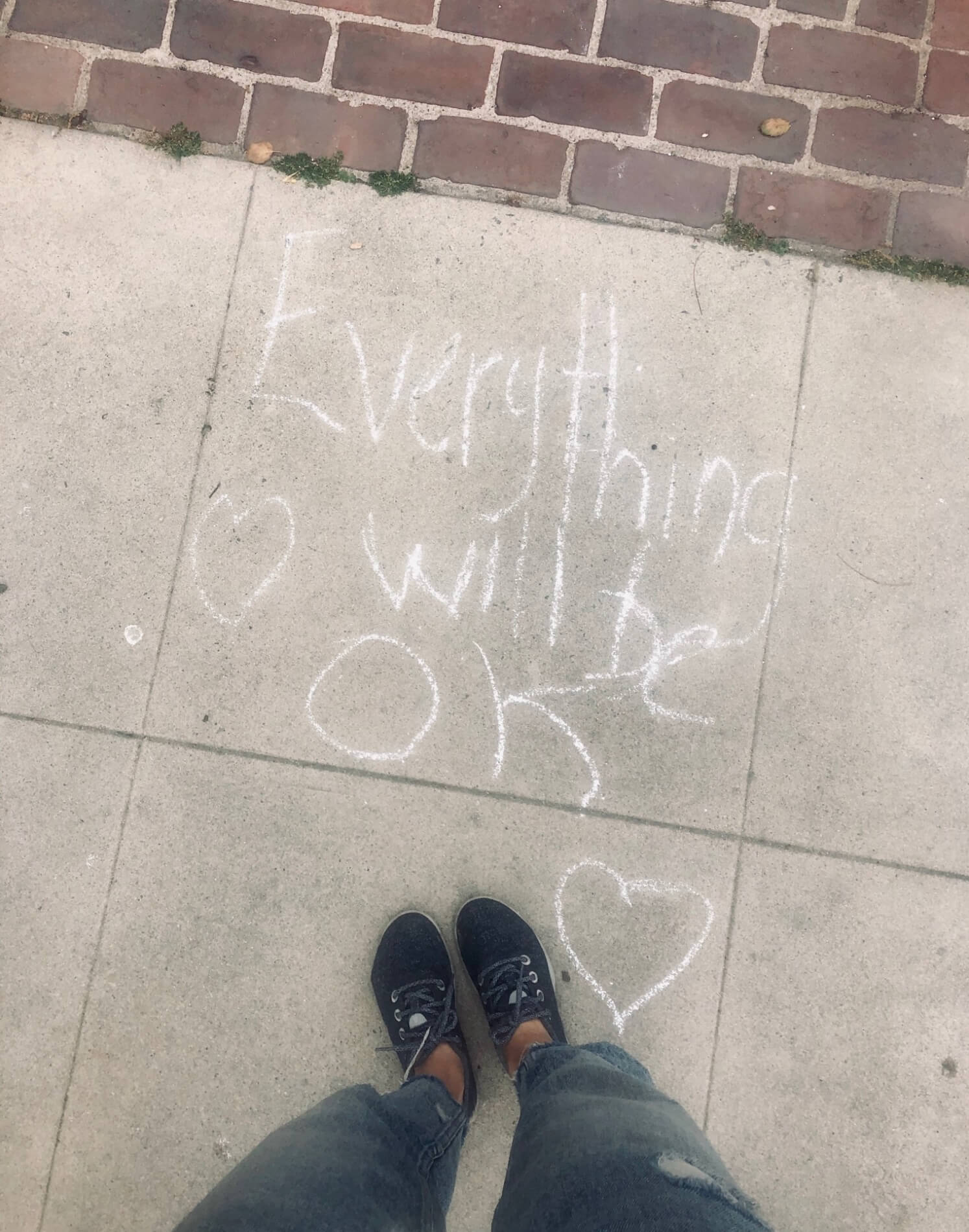 A note written in chalk on a sidewalk says "Everything will be ok"