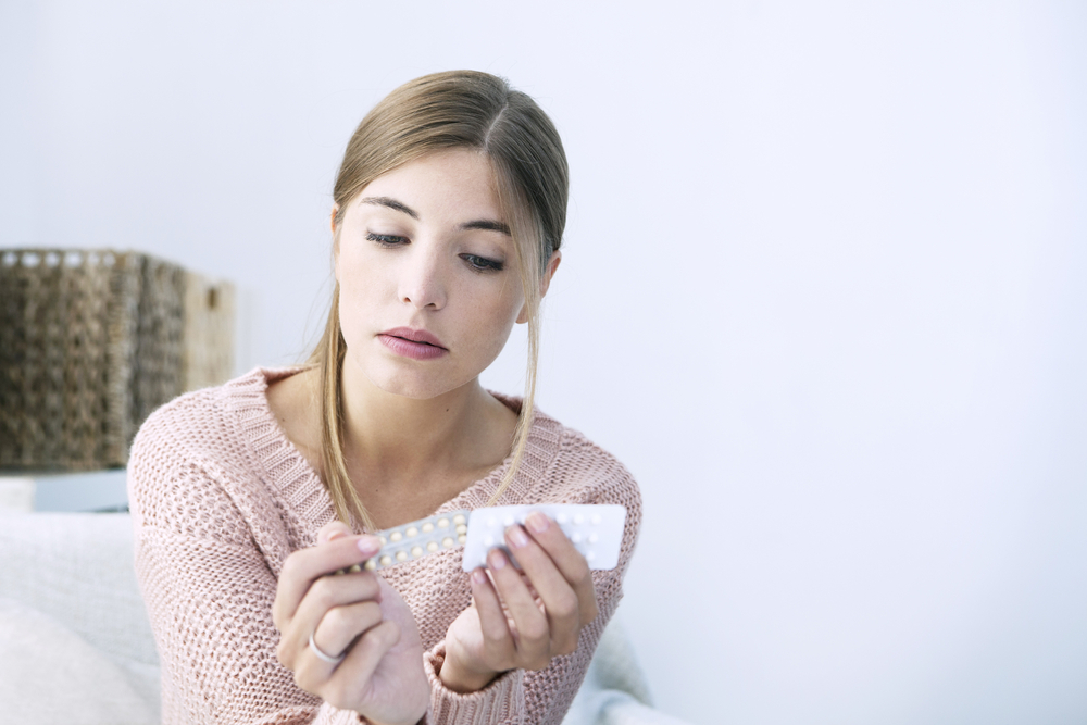 woman with birth control pills