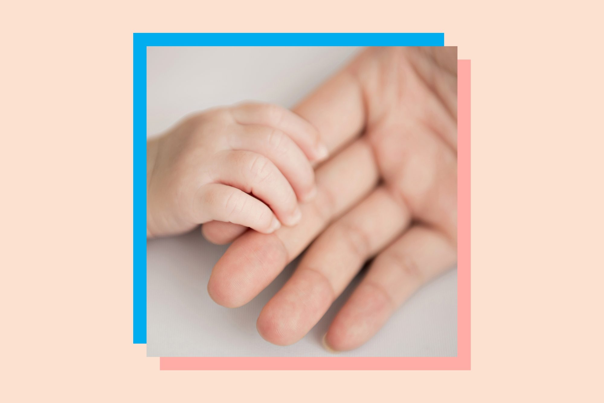 An image of a father's hands holding his child's.