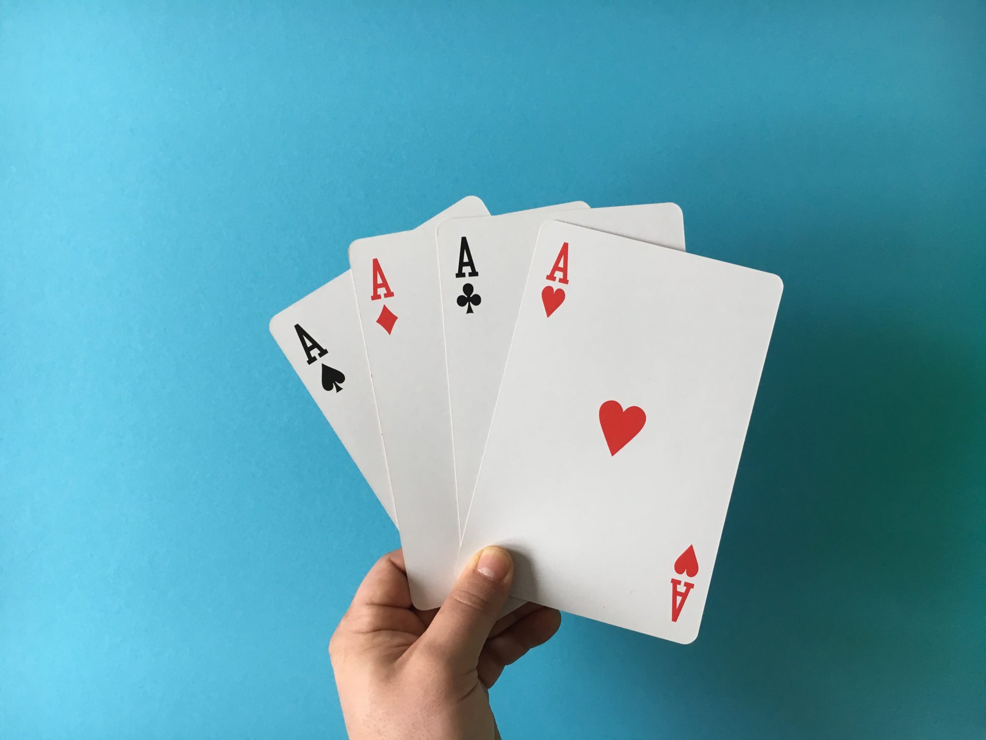 An image of a person holding a deck of cards.
