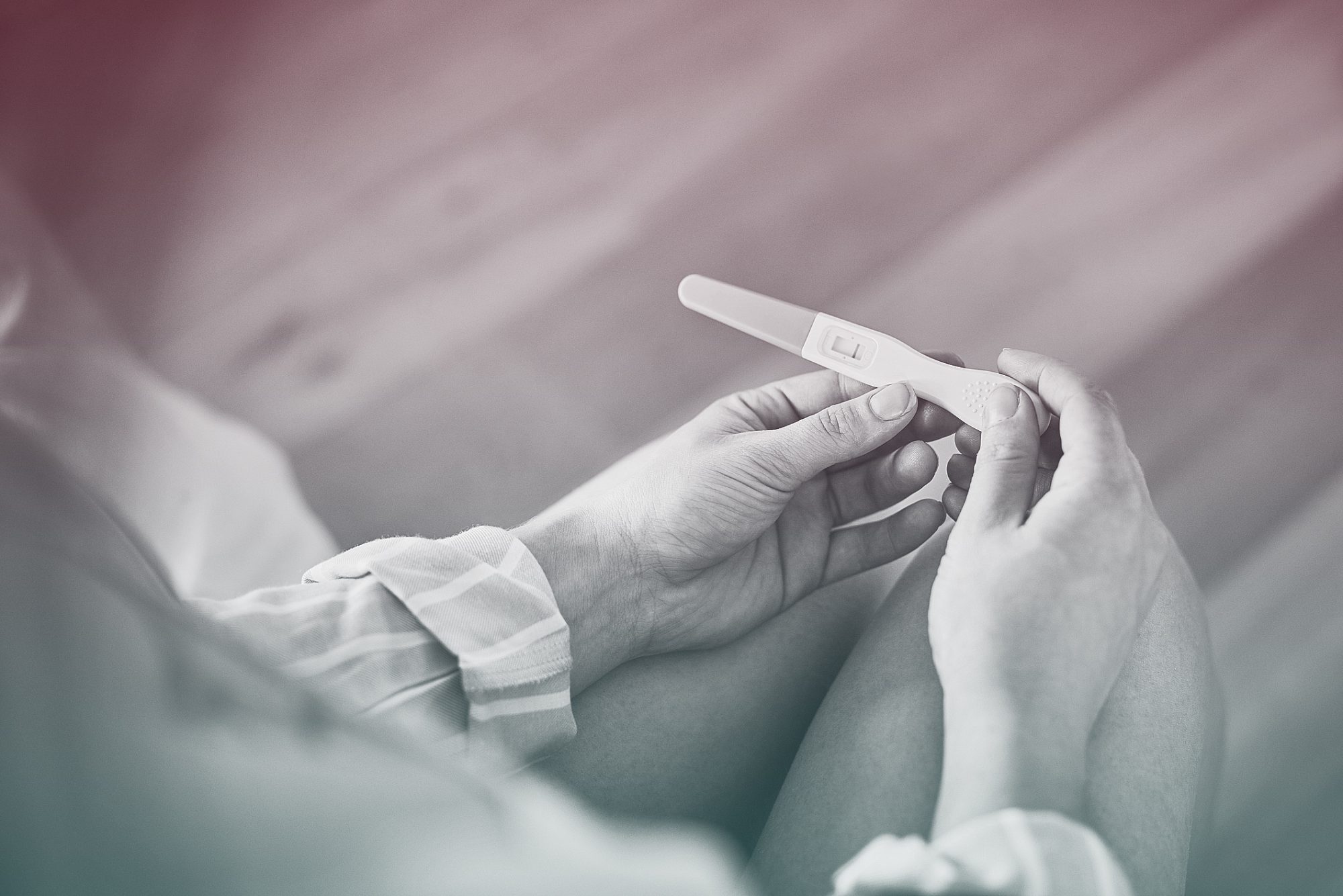 top view of hands holding pregnancy test