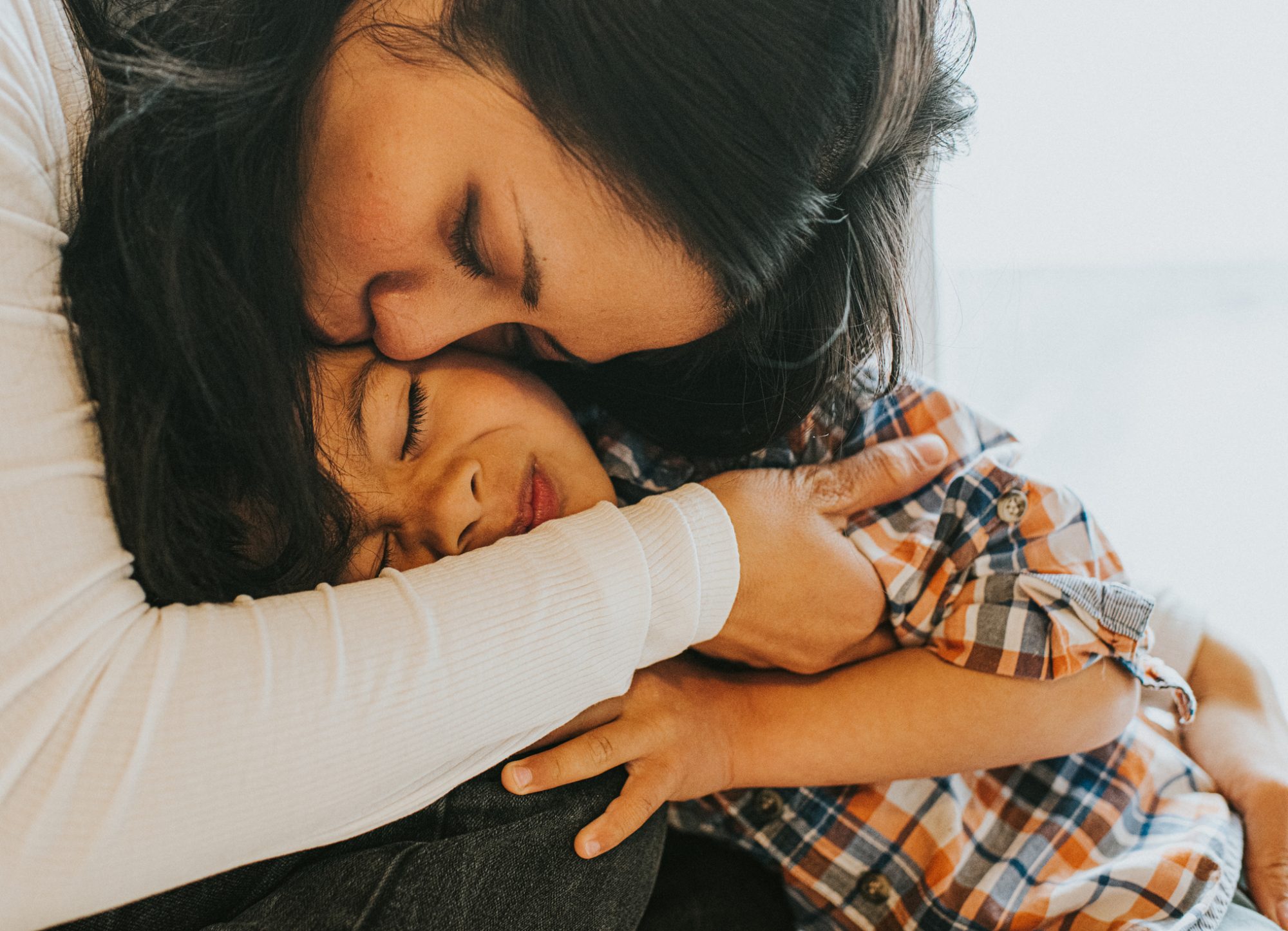 An image of a mother hugging her young son.