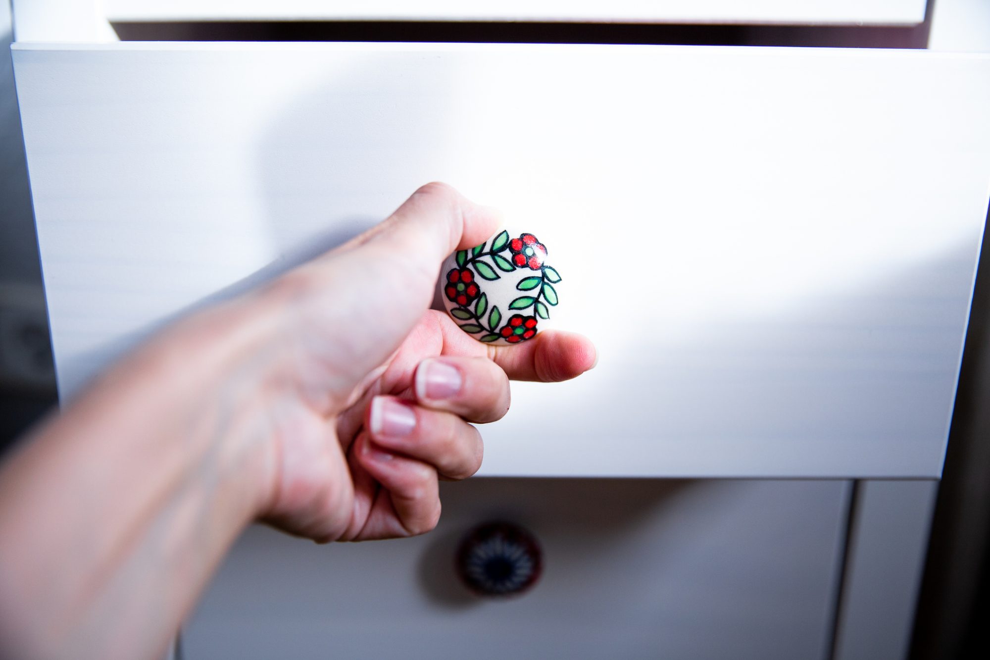 An image of a person's hands opening a drawer.