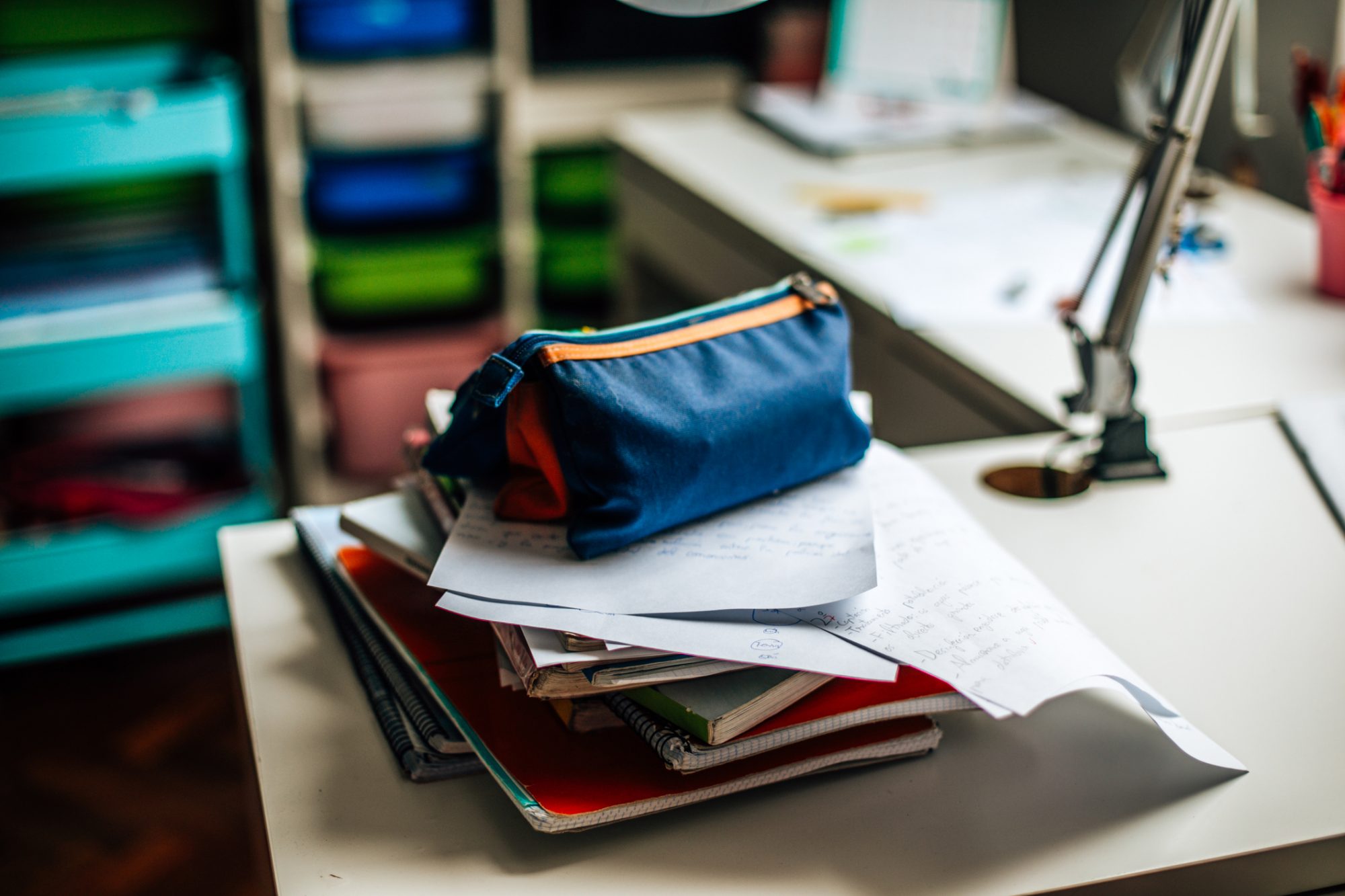 An image of school supplies and notebooks on a desk.