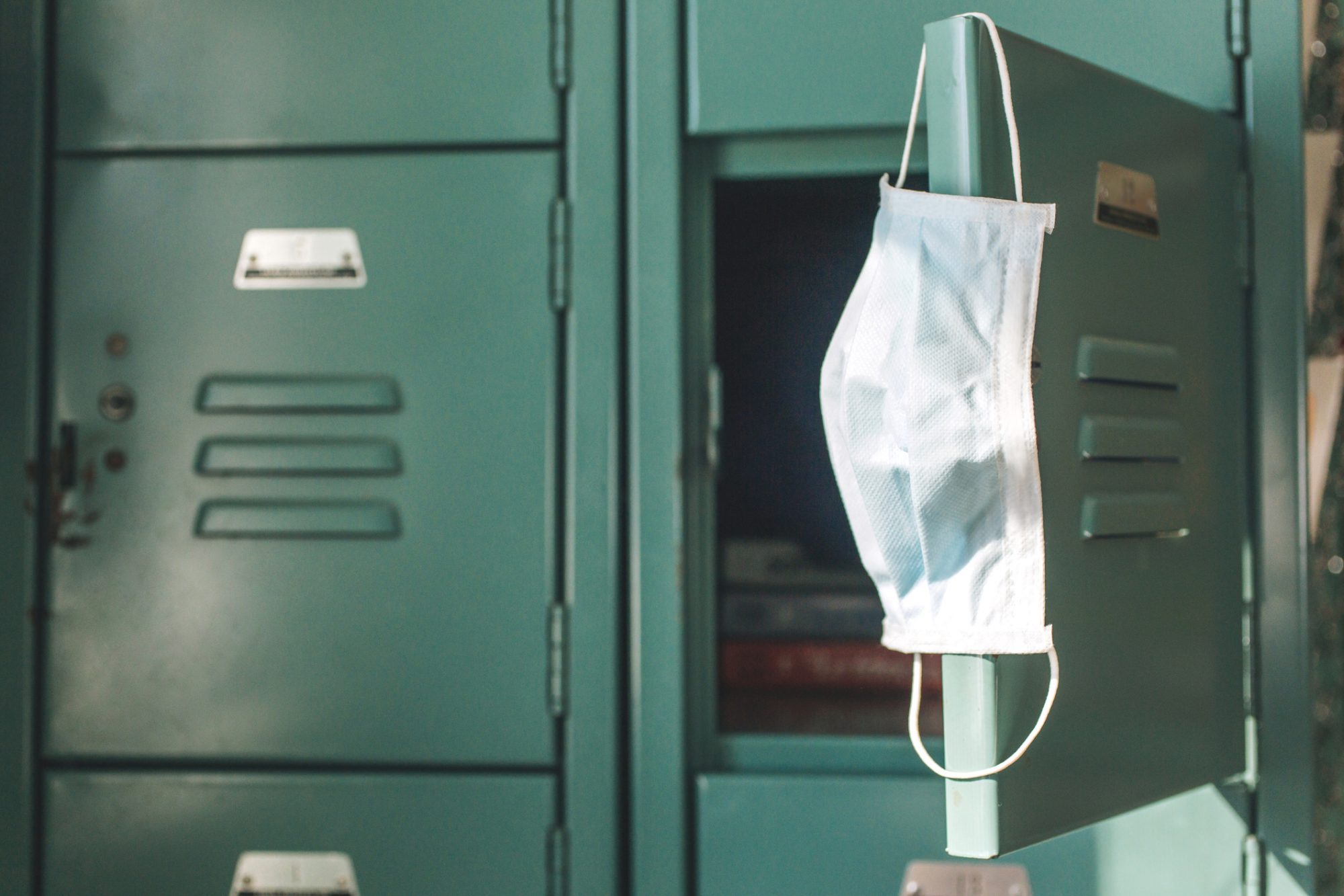 An image of a mask on a school locker.