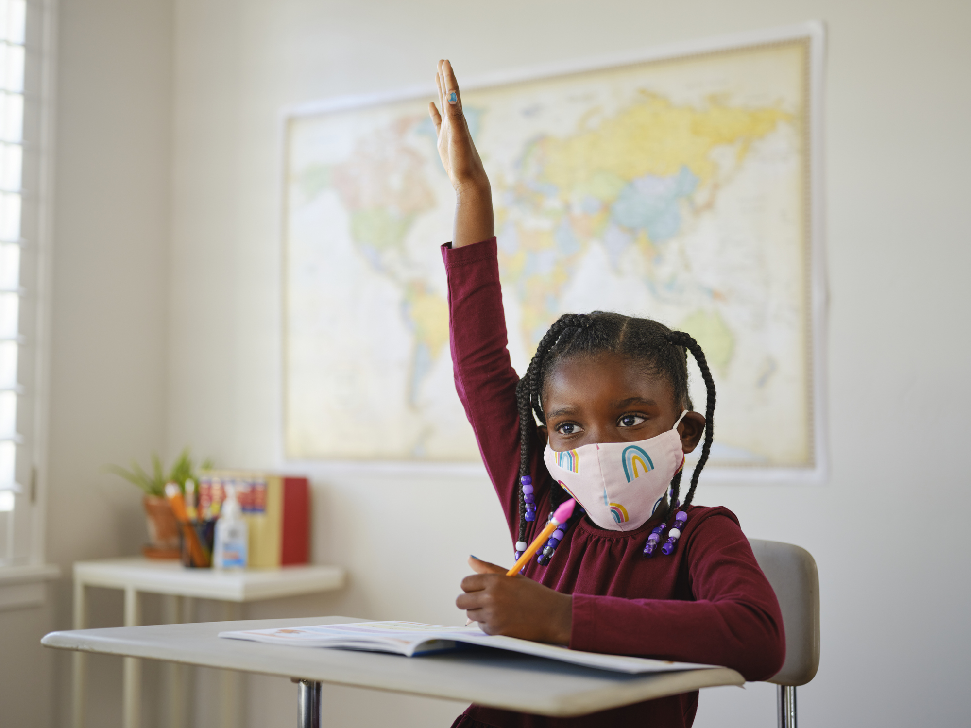 An image of a child in school with a mask on.