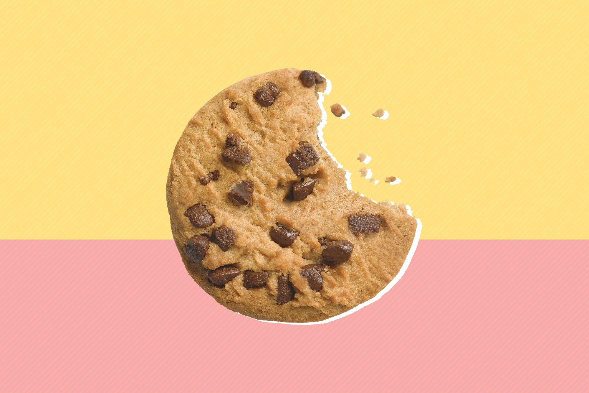 Chocolate chip cookie with one bite bitten into it with crumbs