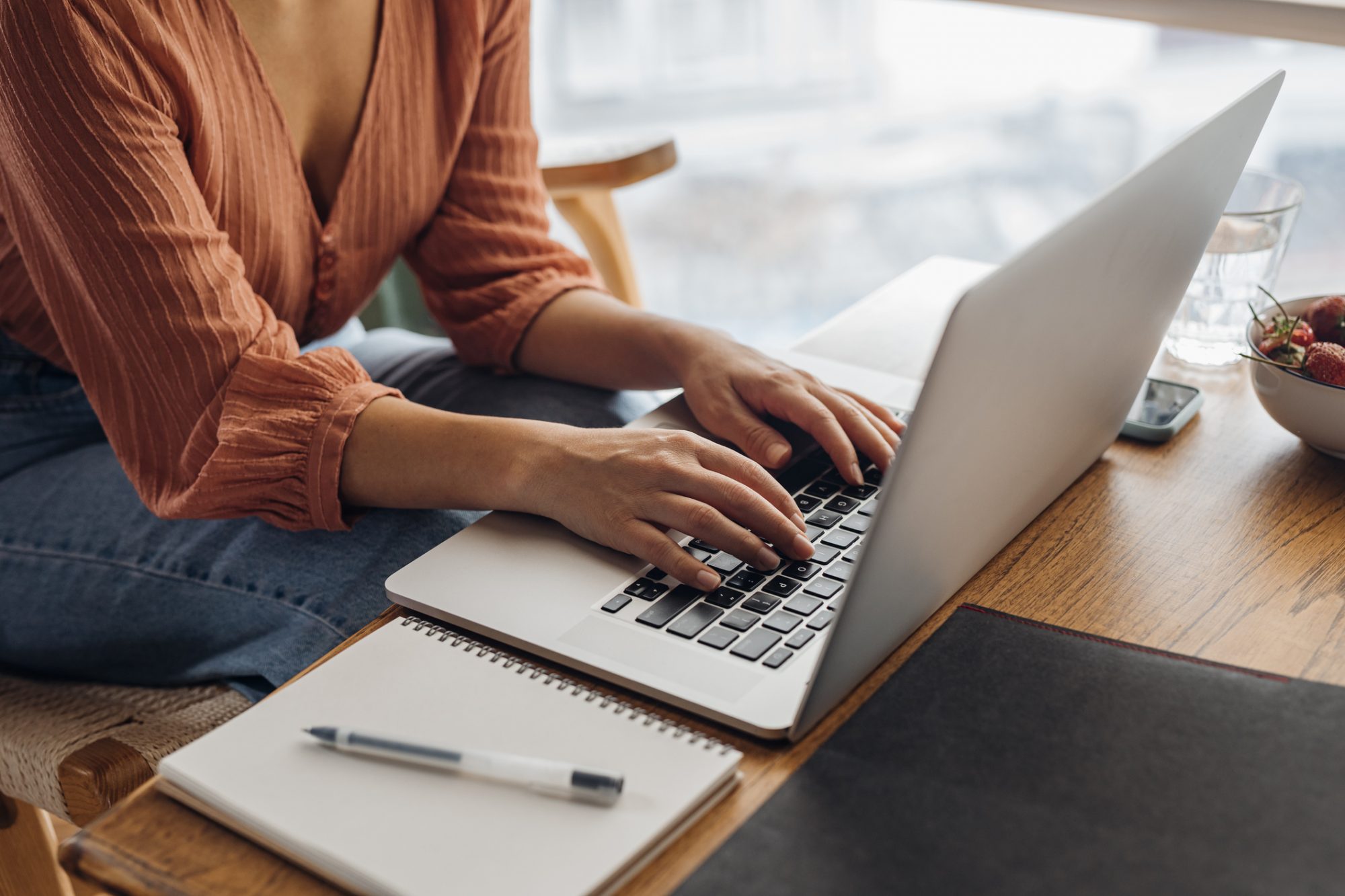 An image of a woman working on a computer.