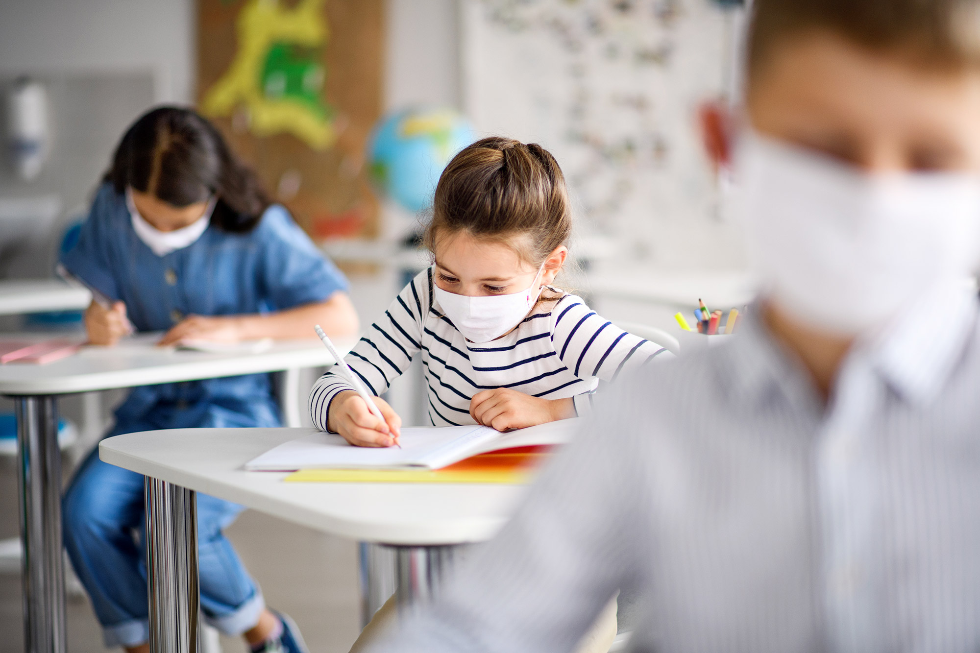 Children with face mask back at school after covid-19 quarantine and lockdown.