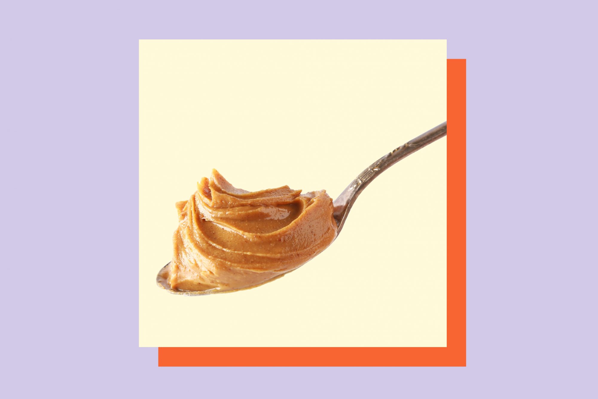 A photo of a spoon of peanut butter on a colorful background.