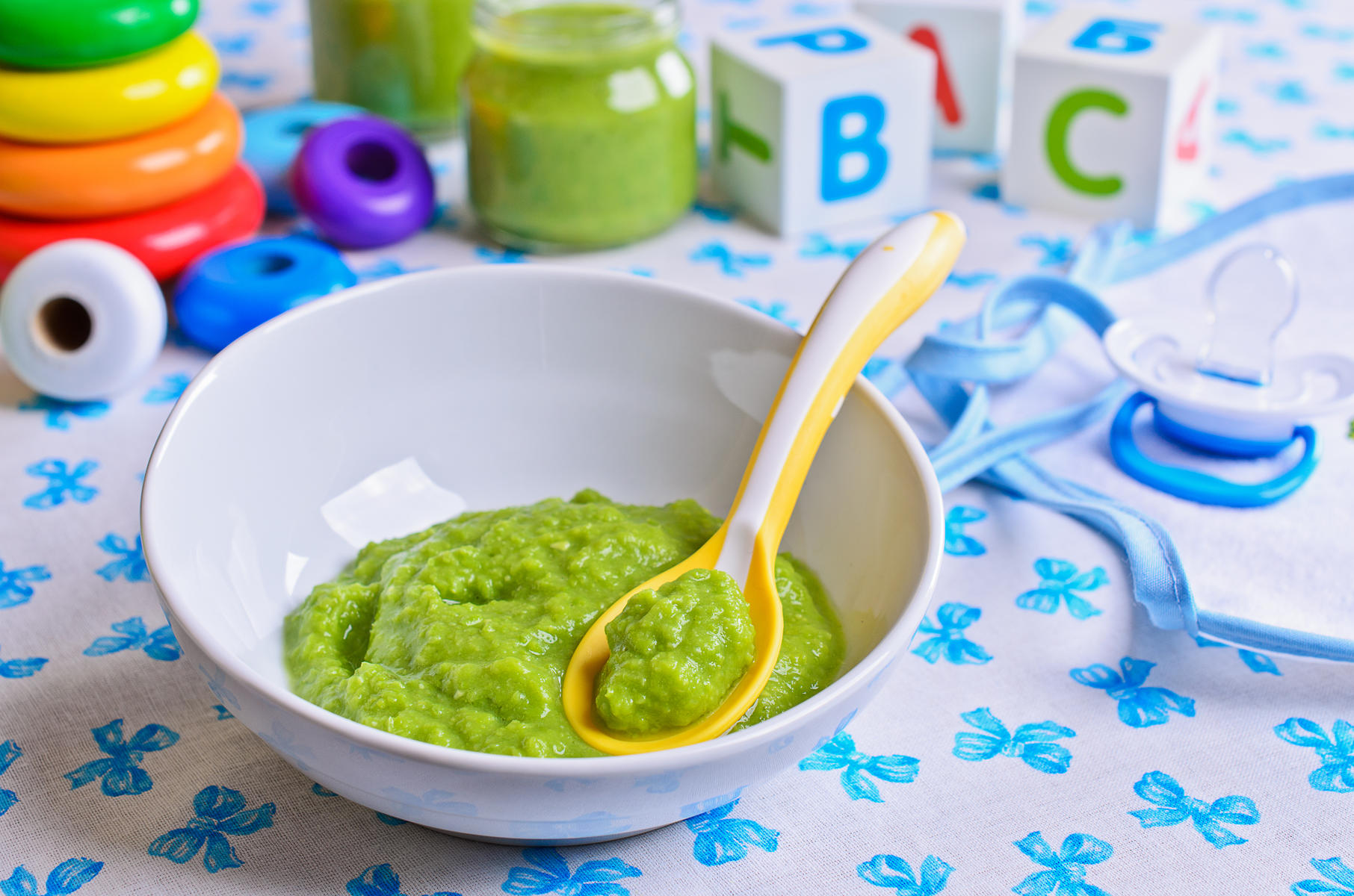 Green Puree Baby Food With Baby Toys