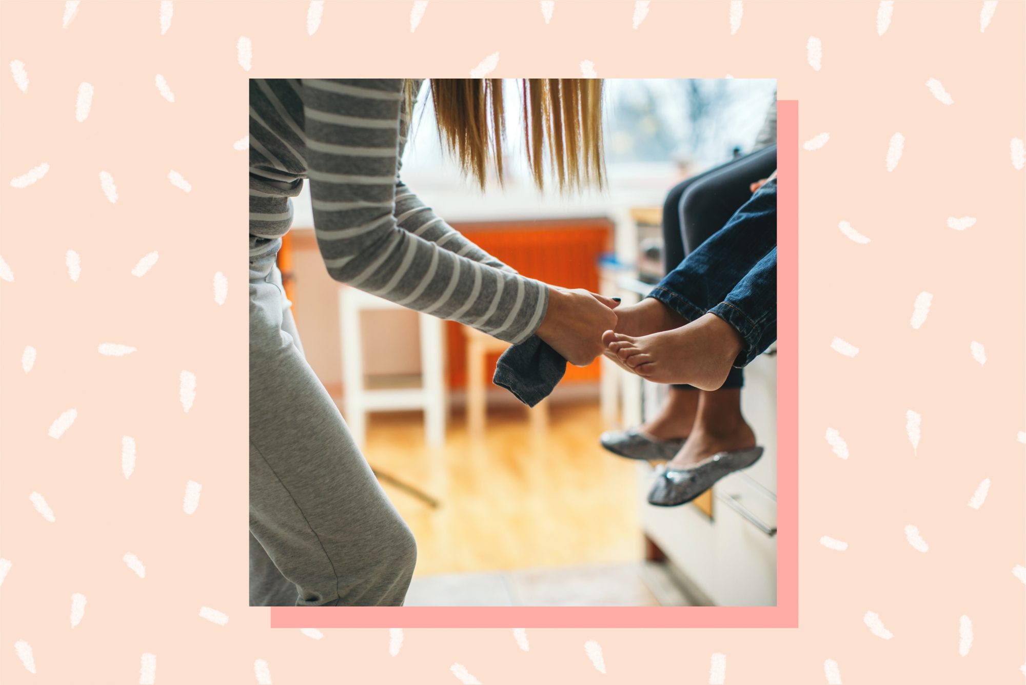 woman putting socks on children