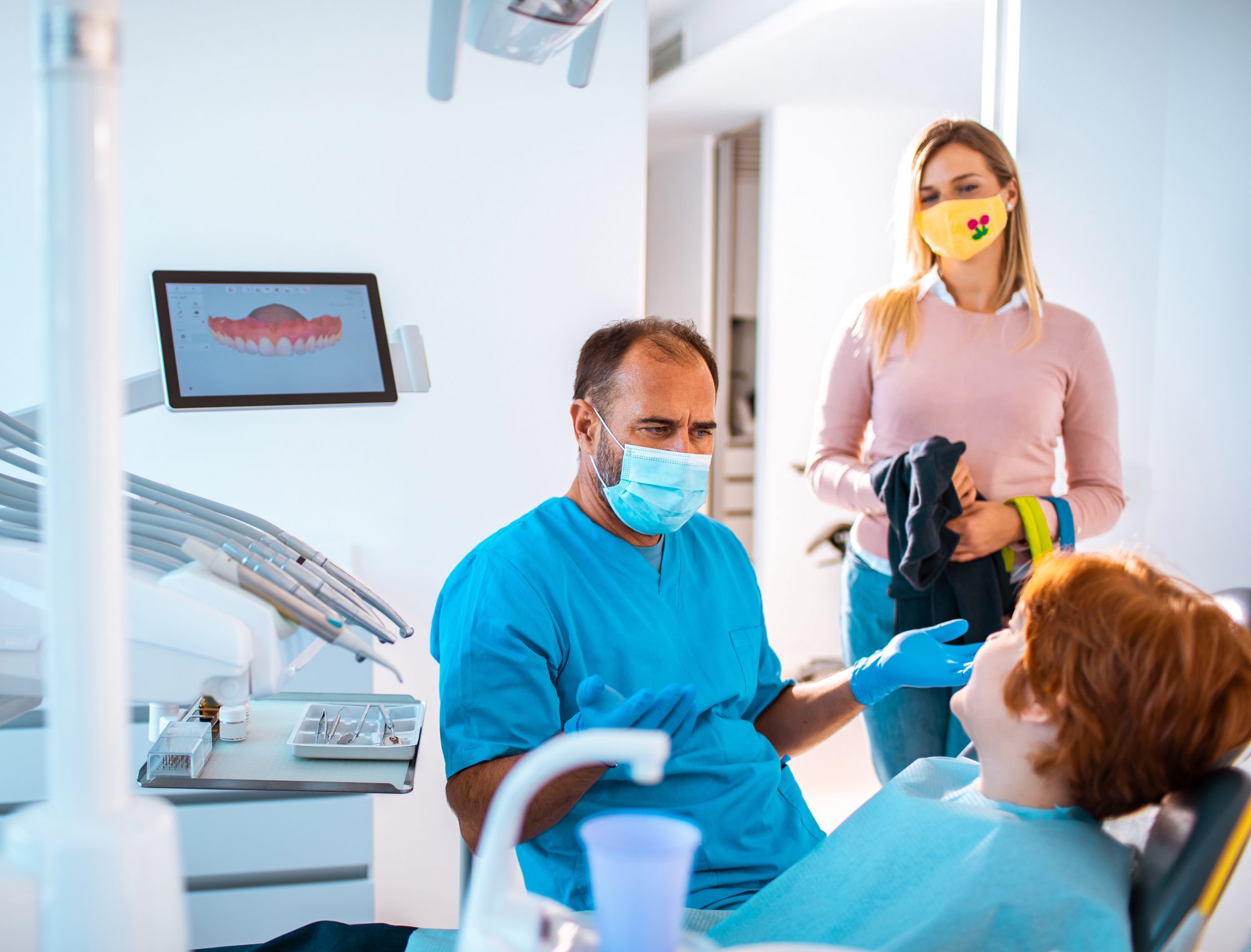 An image of a mother taking her son to the dentist during COVID.