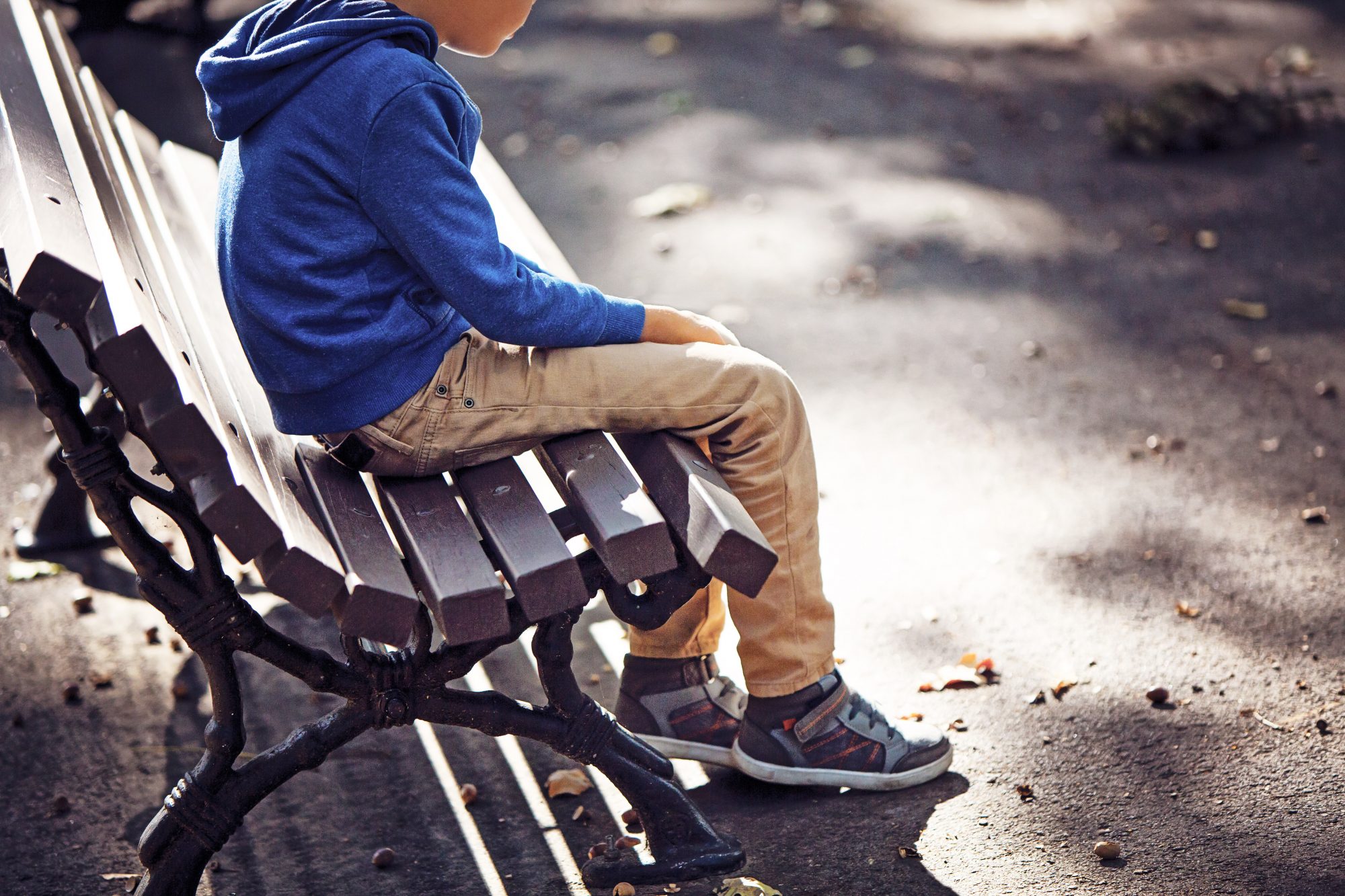 A image of a boy on a bench.