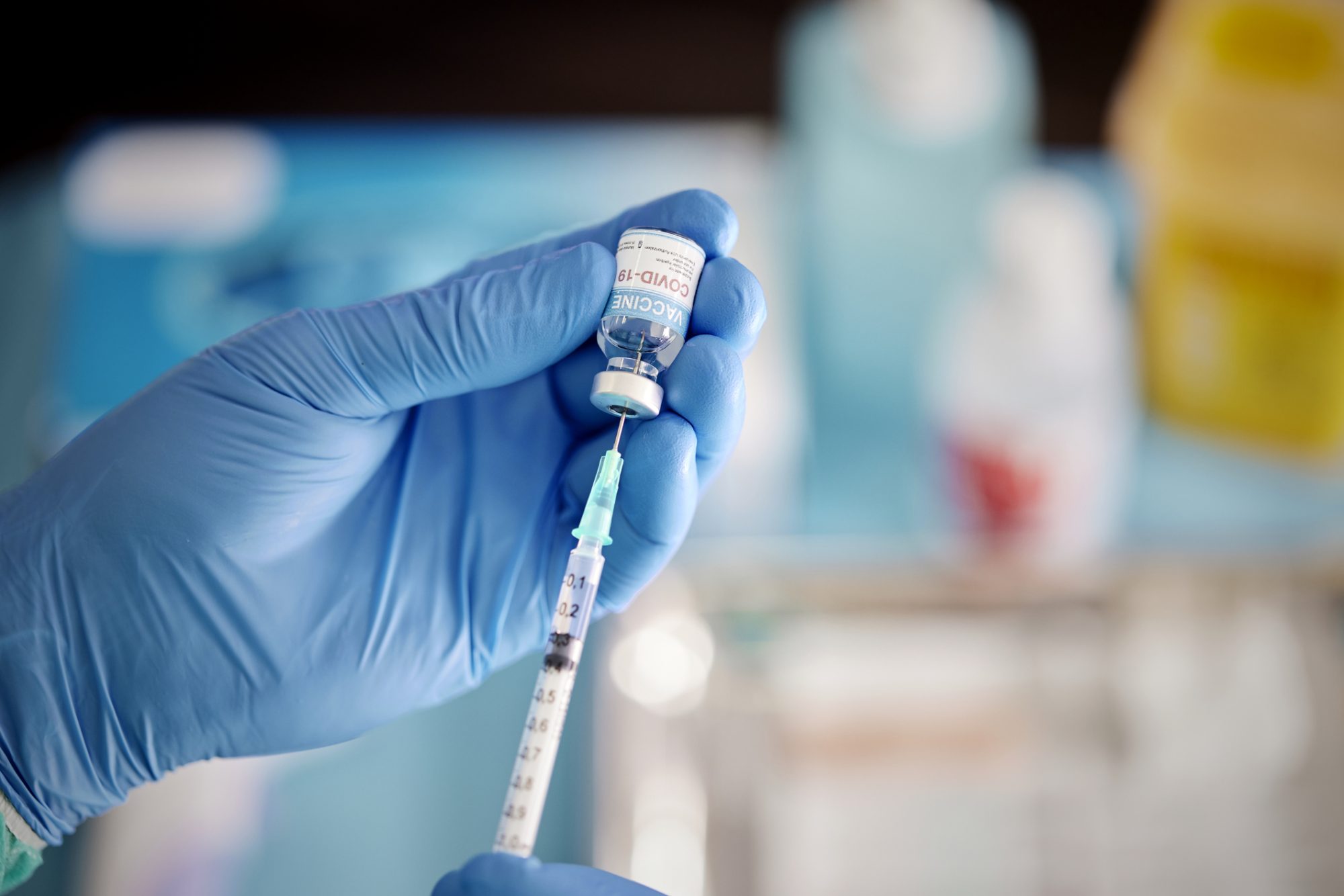 An image of A healthcare worker preparing a Dose of COVID-19 Vaccine.