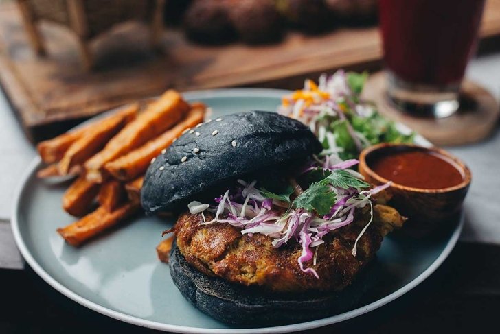 Charcoal black bun burger served for dinner