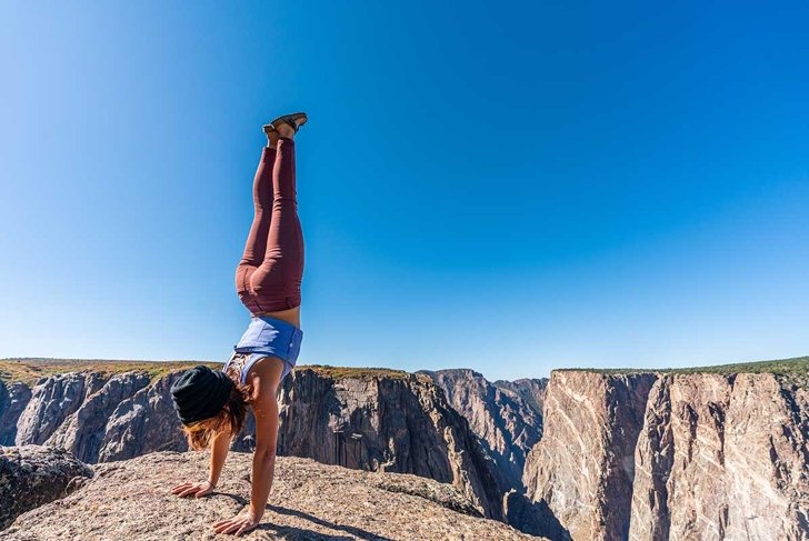 Woman Doing Handstands and Looking Over the Black Canyon of the Gunnison